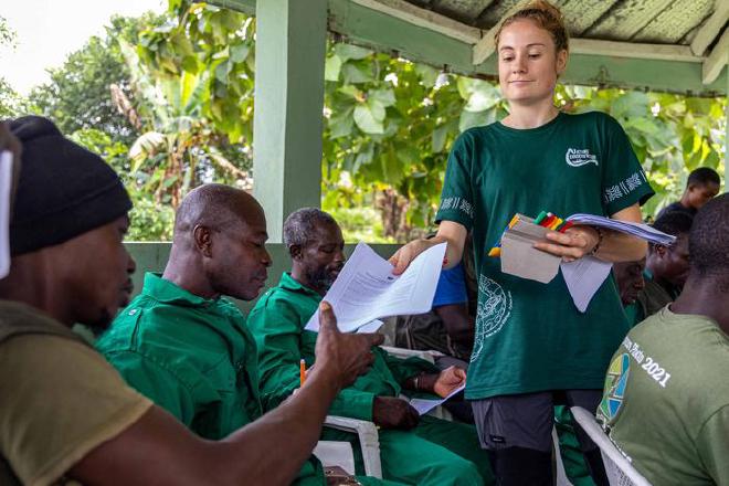 Nature Conserv&rsquo;Action volunteer, Coline Hervoche, distributes Under the Snakefluence surveys, at a guide training in Côte d&rsquo;Ivoire. Photo by Michiel van Noppen