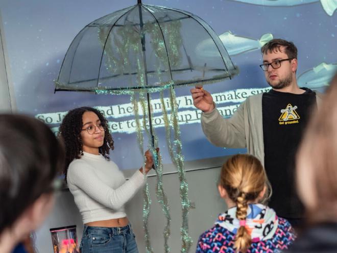 Amara Mcpherson-Bassey and Liam Babcock presenting the moon jelly. Credit: UW