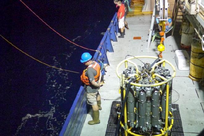 Adam Martiny (middle) participates in ocean shipboard sampling on board the ocean-going Global Ocean Ship-based Hydrographic Investigations Program. Image credit: Celine Mouginot / UC Irvine