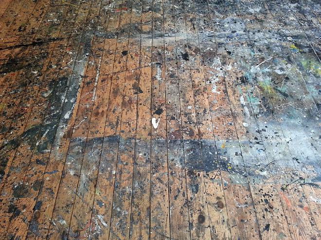 Studio floor used by Jackson Pollock at the Pollock-Krasner House and Study Center in Springs, New York. The studio is in an old barn behind the house. Pollock had the building moved, put a wood floor down and used it as his primary painting surface from 1946 until his death in 1956. When he renovated in 1953, he put down a masonite covering. Krasner started to use the room in 1957. Upon her death in 1984, ownership was transferred to Stony Brook University, who removed the covering, discovered the old surface, and had it restored in 1987-8. Credit: <a href="https://commons.wikimedia.org/wiki/User:Rhododendrites" target="_blank">Rhododendrites</a>