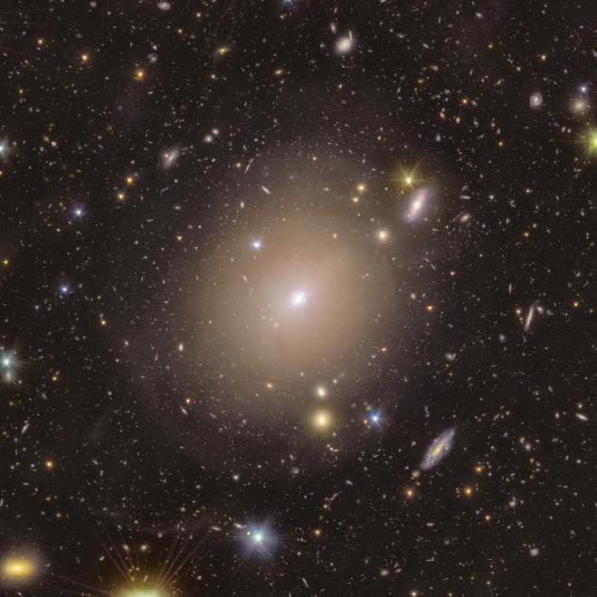 The ring of light surrounding the centre of the galaxy NGC 6505, captured by ESA’s Euclid telescope, is a stunning example of an Einstein ring. NGC 6505 is acting as a gravitational lens, bending light from a galaxy far behind it. The almost perfect alignment of NGC 6505 and the background galaxy has bent and magnified the light from the background galaxy into a spectacular ring. This rare phenomenon was first theorised to exist by Einstein in his general theory of relativity. This wide field shows the extended stellar halo of NGC 6505 and showcases the Einstein ring, surrounded by colourful foreground stars and background galaxies. Credit: ESA/Euclid/Euclid Consortium/NASA, image processing by J.-C. Cuillandre, T. Li