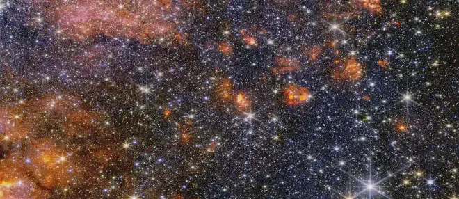 Stars, gas and cosmic dust in the Sagittarius B2 molecular cloud glow in near-infrared light, captured by Webb’s NIRCam (Near-Infrared Camera). In this light, astronomers see more of the region’s diverse, colourful stars, but less of its gas and dust structure. Webb’s instruments each provide astronomers with important information that help build a more complete picture of what is happening in this intriguing portion of the centre of our galaxy.