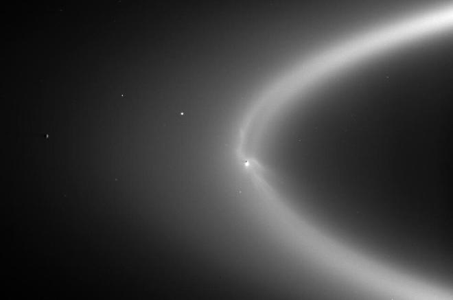Saturn’s E ring is a huge, fuzzy, donut-shaped circle of particles around Saturn, that puzzled scientists for a long time. Thanks to the Cassini-Huygens mission, scientists realised that the ring is actually created by particles left behind in the wake of Saturn’s icy moon Enceladus. This view, taken by Cassini on 15 September 2006, at a distance of about 2 million km from Enceladus, shows a plume emanating from the moon’s south polar region. This plume is created as water from Enceladus’s underground ocean spews out of cracks in its icy surface. Image credit: NASA/JPL/Space Science Institute