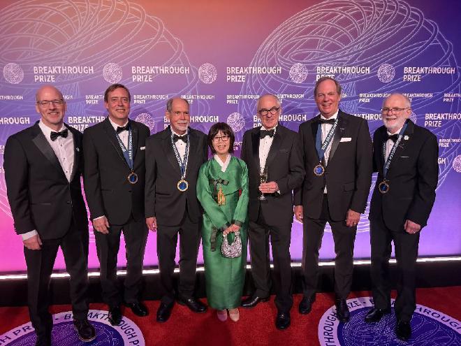 At the Breakthrough Prize ceremony on April 18, 2026, left to right: Brookhaven National Laboratory Interim Director John Hill, Fermi National Accelerator Laboratory (Fermilab) physicist Chris Polly, Boston University physicist Lee Roberts, Fermilab Director Emeritus Young-Kee Kim, CERN Director General Mark Thomson, University of Washington physicist David Hertzog, and Brookhaven Lab physicist William Morse. (Image courtesy of Kat Morse)